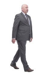 Mature business man striding forward .isolated on a white background.