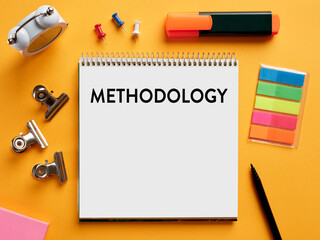 The word methodology written on a notebook on business office desktop.