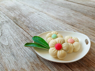 Homemade traditional shortbread cookies in flower shape on rustic wooden table background with copy space.