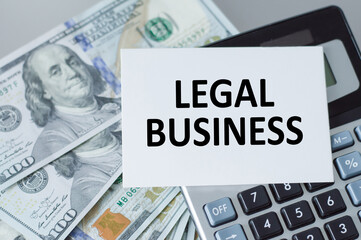 Legal business text card, which is on the calculator next to it on the table of dollar currency