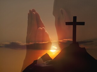 Young person praying and silhouette jesus christ cross against sky. spirituality, religion,...