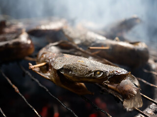 Picture of catfish that on a smoking process that make the taste more delicious