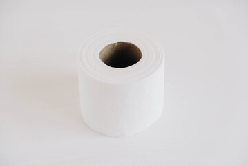 Roll of white toilet paper on a white background
