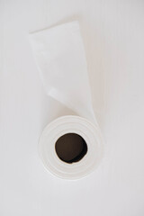 Roll of white toilet paper on a white background