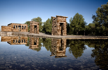 panorama of the Debod temple reflected in a water pond with blue sky in the city of Madid Spain - 507810134