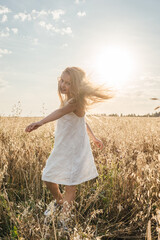 Little girl in field, sunset light.