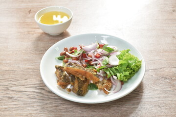 deep fried slice snake skin gourami spicy and sour Thai salad on dish