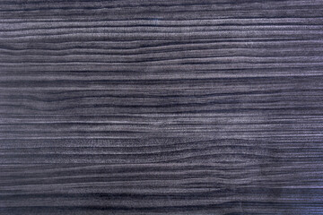 Black wooden background with horizontal grain
