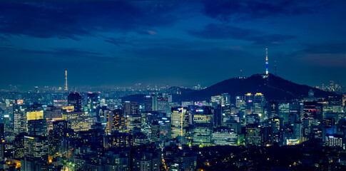 Seoul downtown cityscape illuminated with lights and Namsan Seoul Tower in the evening view from...