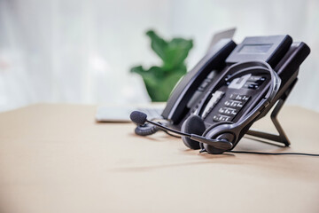 Communication support, call center and customer service help desk. telephone devices with VOIP headset in office.Customer service support (call center) concept.