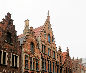 Fototapeta premium ancient houses with gabled facades in the medieval part of the town Bruges, Belgium