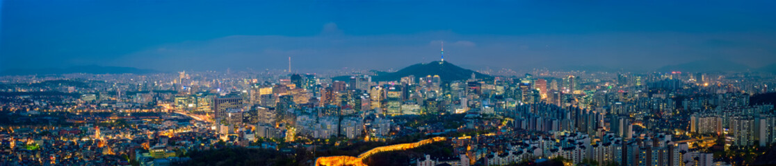 Fototapeta na wymiar Panorama of Seoul downtown cityscape illuminated with lights and Namsan Seoul Tower in the evening view from Inwang mountain. Seoul, South Korea.
