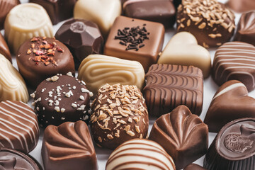 Assortment of dark, white and milk chocolate on white background