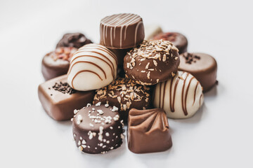 Assorted of dark, white and milk chocolate isolated on white background. Truffle, candy with decoration design. Various candy fillings. View from above