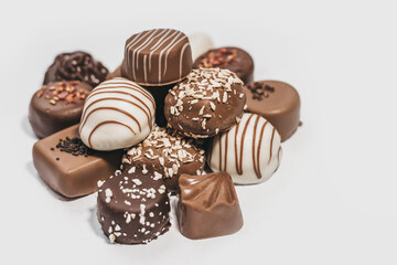 Assorted of dark, white and milk chocolate isolated on white background. Truffle, candy with decoration design. Various candy fillings. View from above