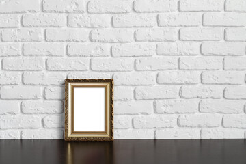 Blank picture frame against brick wall with copy space