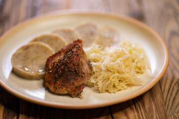 typical Czech cuisine pork with dumplings and cabbage