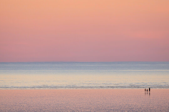 A family is enjoying the beautiful view at 80 mile beach, in Broome, Western Australia