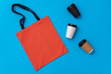 Textile shopping bag and coffee cup flat lay