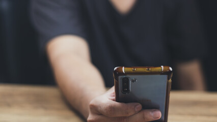Social media technology concept, men's hands using smartphones to login social media, work from home or do online marketing. business and finance