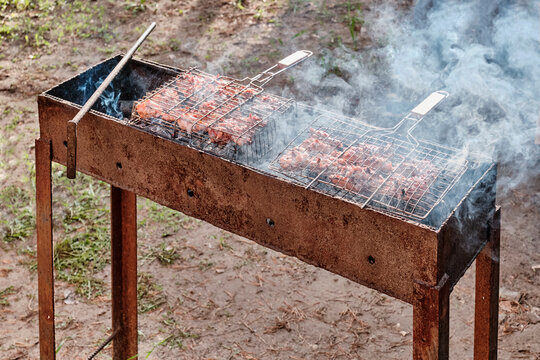 Chicken Meat Is Cooked On Barbecue Grill In Backyard.