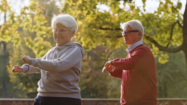 Senior Caucasian couple doing sports in park medium shot . High quality photo