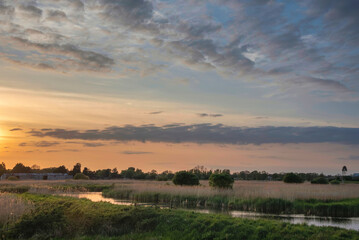 Fototapeta na wymiar Stunning landscape sunset image of Somerset Levels wetlands in England during Spring evening