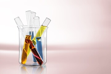 Glass laboratory equipment filled with fluid in a beaker test tube in lab background for experiment advertising