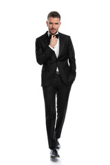 businessman walking with a tough look on his face