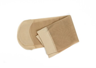Women's nylon tights body color isolated on white background. Women's nylon stockings beige color. 