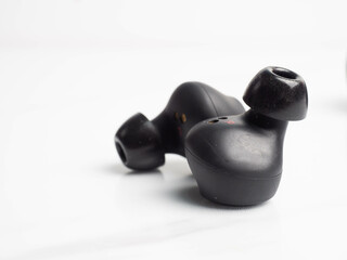 A pair of black wireless earphone with case