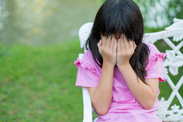 girl sitting on a chair in the garden