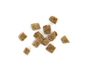 Bread croutons on a white background. Scattered pile of homemade rye bread croutons isolated on white background top view. Crispy bread cubes, dry rye crumbs, rusks, crouoton or brown roasted crackers