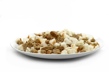 Bread croutons on a white background. Scattered pile of homemade rye bread croutons isolated on white background top view. Crispy bread cubes, dry rye crumbs, rusks, crouoton or brown roasted crackers