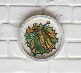 Mid-century modern pottery - wall plaque with a colorful autumn leaf