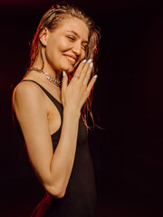 Obraz premium Beautiful smiling young woman applying hair conditioner