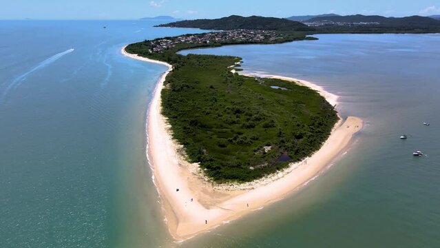 Aerial drone view of peninsula in tropical beach with vegetation and strip of sand in daniela beach Florian&oacute;polis