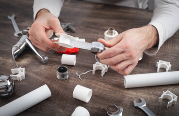 Plumber putting a teflon tape. Repair of water pipes