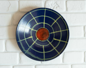 Mid-century modern pottery - blue wall plate with spider web pattern