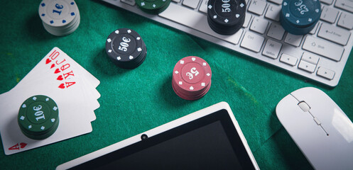 Computer keyboard, mouse, playing cards and chips. Online casino