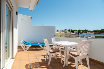 table with chairs in terrace of modern apartment