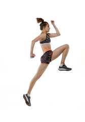 Development of movements in long jump sport. One professional female athlete in sports uniform jumping isolated on white background.