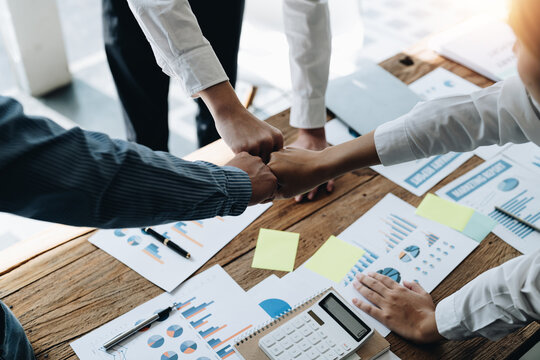 diverse group of asian business partner fist bump in modern office. Colleague partnership teamwork, university student, congratulation event, job or mission accomplish concept