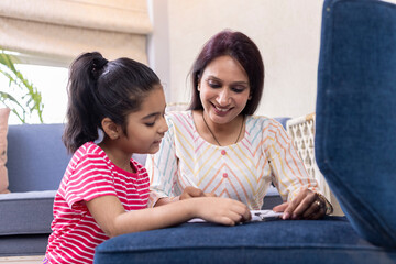 Mother helping daughter with homework