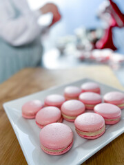 Woman chef making macarons - stock photo