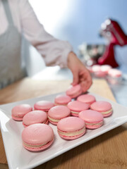 Woman chef making macarons - stock photo