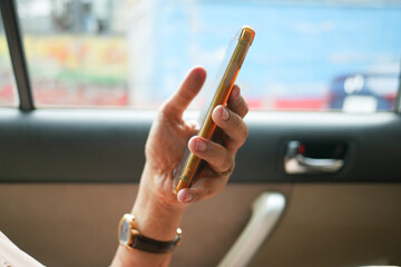  women hand holding smart phone in a car 