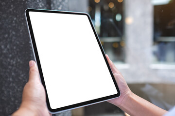 Mockup image of a woman holding digital tablet with blank white desktop screen