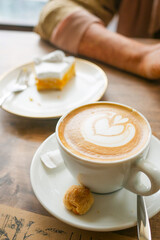 a cup of late coffee with flower shape design on top at cafe 