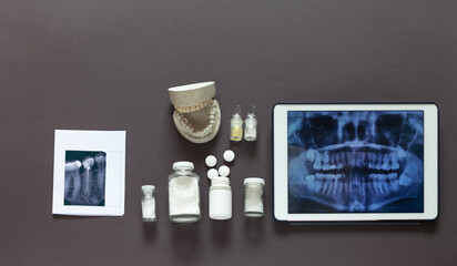 Concept of timely dental treatment. Plain x-ray of all teeth on tablet and separate x-ray of...